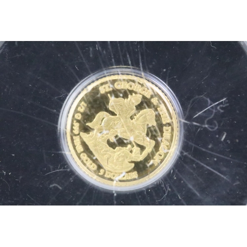 244 - A Westminster Mint 2010 gold quarter sovereign presentation coin cover together with a 2010 George &... 