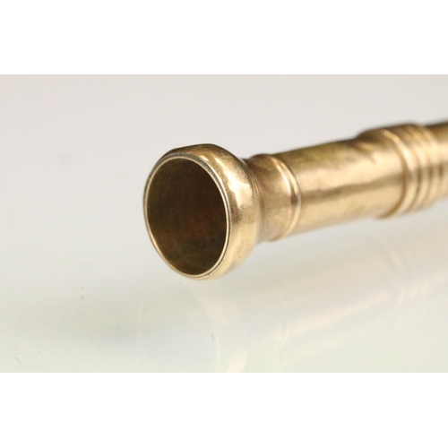 153 - 9ct gold cigar piercer having banded detailing. Hallmarked Birmingham 1910. Measures 8.3cm.