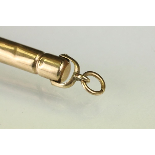 153 - 9ct gold cigar piercer having banded detailing. Hallmarked Birmingham 1910. Measures 8.3cm.