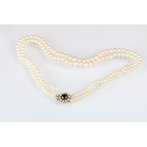 39 - Two strand cultured pearl necklace having graduating pearls with a pink overtone mounted to a knotte... 