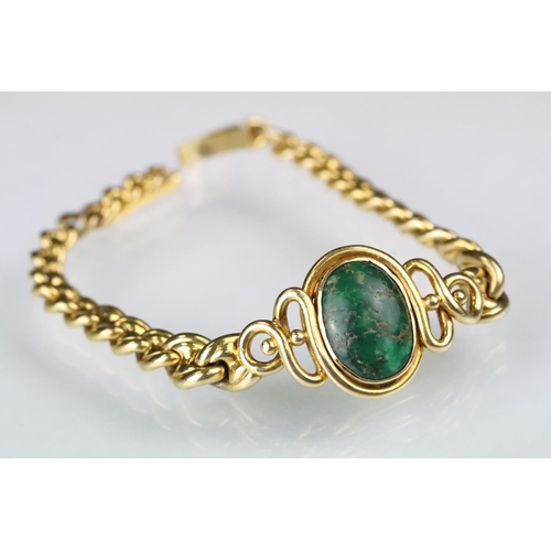 45 - Green turquoise and gold bracelet having an oval turquoise cabochon set to the centre within a cross... 