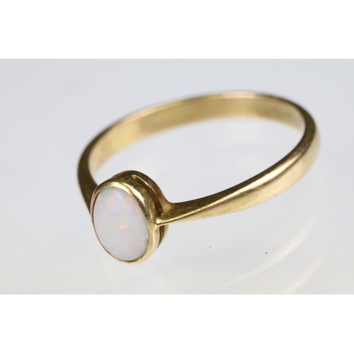 160 - Yellow gold and opal single stone ring bezel set with an oval opal cabochon to a plain band with pin... 