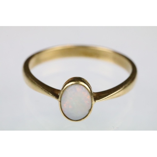 160 - Yellow gold and opal single stone ring bezel set with an oval opal cabochon to a plain band with pin... 