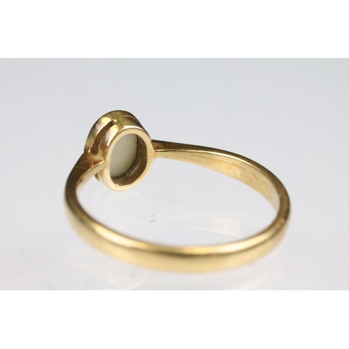 160 - Yellow gold and opal single stone ring bezel set with an oval opal cabochon to a plain band with pin... 