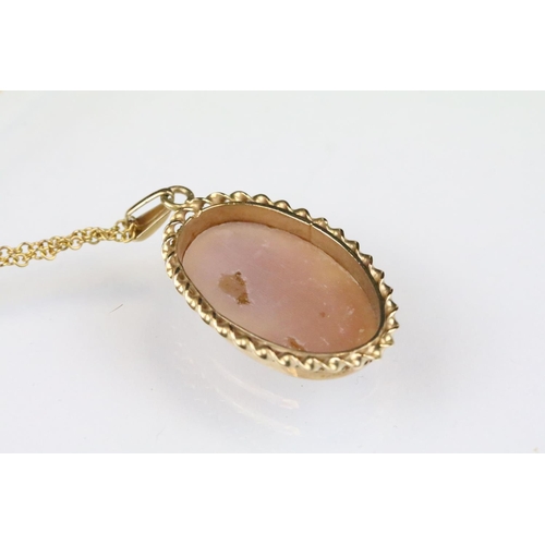 165 - Hallmarked 9ct gold cameo pendant with carved shell cameo, mounted to a 9ct gold chain. Pendant hall... 