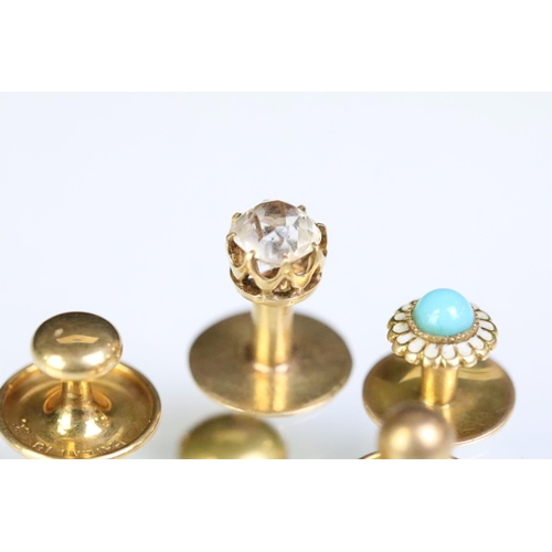 233 - Four yellow metal dress studs and one gold plated example. Yellow metal example one set with a round... 