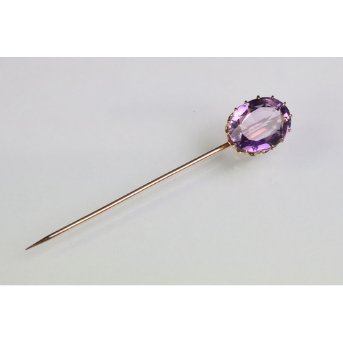 234 - Late 19th Century Victorian amethyst and gold stick pin being set with a large oval mixed cut amethy... 