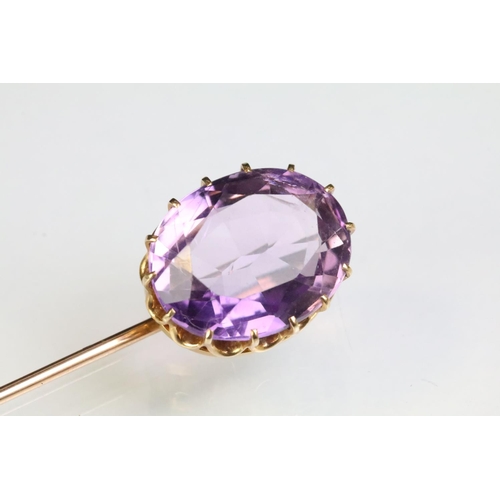 234 - Late 19th Century Victorian amethyst and gold stick pin being set with a large oval mixed cut amethy... 