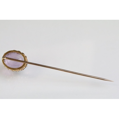 234 - Late 19th Century Victorian amethyst and gold stick pin being set with a large oval mixed cut amethy... 