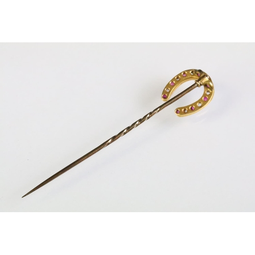 24 - 19th Century Victorian horseshoe stick pin, the finial being set with alternating rectangular cut ru... 