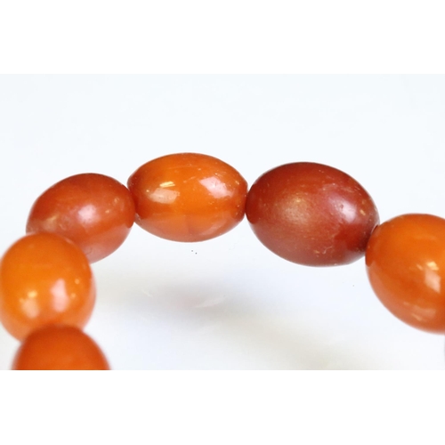 249 - Amber beaded necklace constructed from oval drilled amber beads. Measures 24 inches. Sample bead mea... 