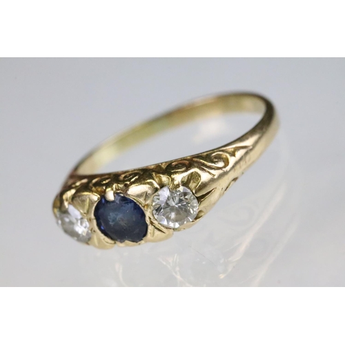 36 - 18ct gold sapphire and diamond boat head ring. The ring being set with a round cut sapphire to the c... 