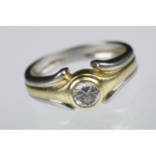 41 - Diamond solitaire ring having a round brilliant cut diamond bezel set on to a two tone band. Marked ... 