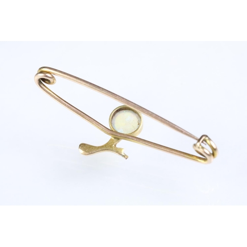 187 - Antique opal and gold safety pin brooch having a round opal cabochon set to the centre. Unmarked, as... 