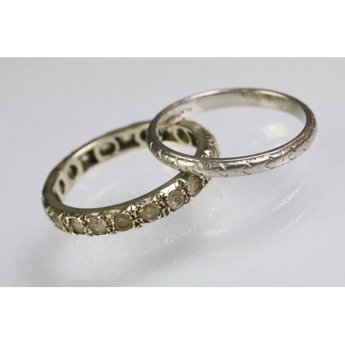 202 - Platinum wedding band ring with incised detailing (marked platinum, size O.5) together with a white ... 