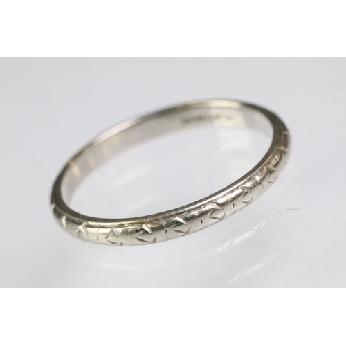 202 - Platinum wedding band ring with incised detailing (marked platinum, size O.5) together with a white ... 