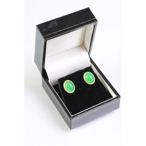 204 - Pair of 14ct gold and jade stud earrings. The earrings being set with oval jade cabochons. Marked 14... 