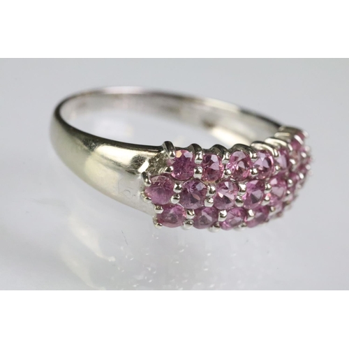 211 - 9ct white gold hallmarked dome ring set with three rows of round cut pink stones. Hallmarked London.... 