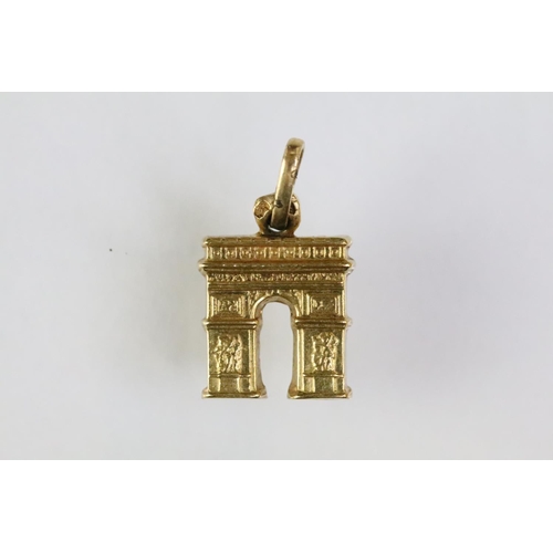 215 - Collection of gold charms to include a 9ct gold hallmarked cross, 14ct gold enamelled flag charm (ma... 