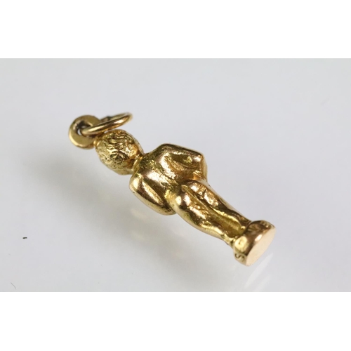 215 - Collection of gold charms to include a 9ct gold hallmarked cross, 14ct gold enamelled flag charm (ma... 