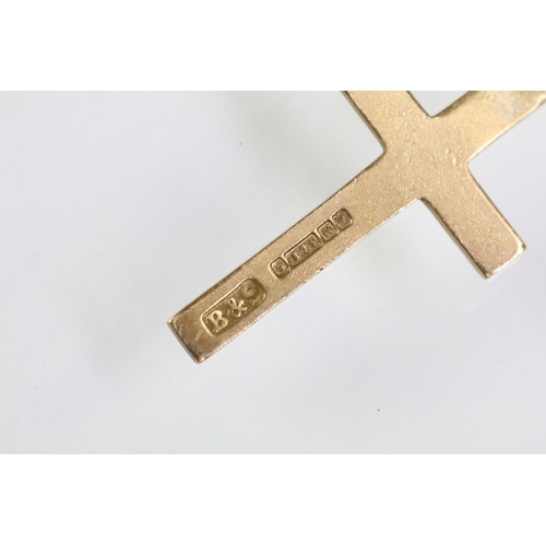 215 - Collection of gold charms to include a 9ct gold hallmarked cross, 14ct gold enamelled flag charm (ma... 