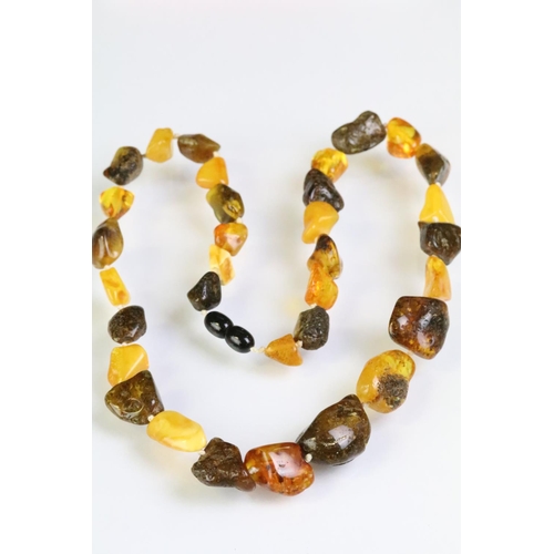 227 - Two amber beaded necklace to include a beaded nugget necklace having contrasting polished amber bead... 