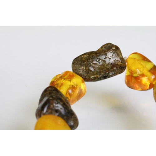 227 - Two amber beaded necklace to include a beaded nugget necklace having contrasting polished amber bead... 