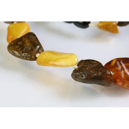 227 - Two amber beaded necklace to include a beaded nugget necklace having contrasting polished amber bead... 