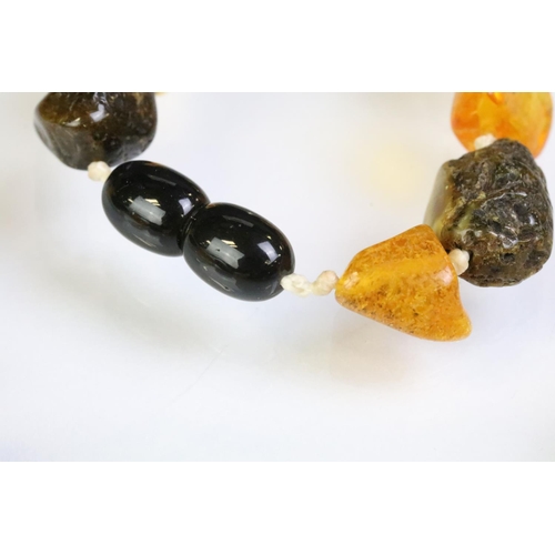 227 - Two amber beaded necklace to include a beaded nugget necklace having contrasting polished amber bead... 