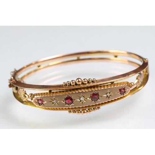 26 - 19th Century Victorian 9ct gold, ruby and diamond hinged bangle bracelet. The bracelet consteucted f... 