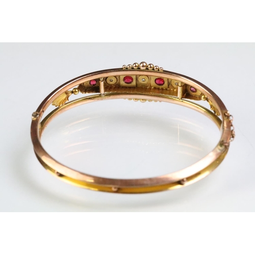 26 - 19th Century Victorian 9ct gold, ruby and diamond hinged bangle bracelet. The bracelet consteucted f... 