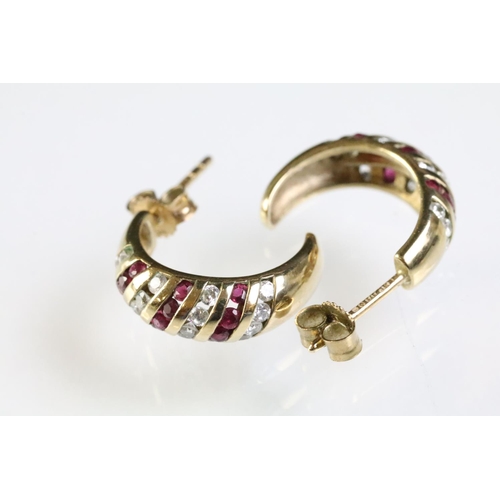 275 - Two pairs of 9ct gold earrings to include a pair of ruby and diamond stud earring set with an oval c... 