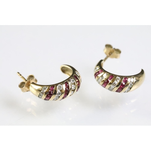 275 - Two pairs of 9ct gold earrings to include a pair of ruby and diamond stud earring set with an oval c... 