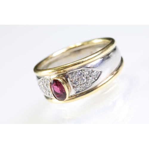 281 - 18ct gold two tone ruby and diamond ring. The ring being bezel set with a oval cut ruby to centre wi... 