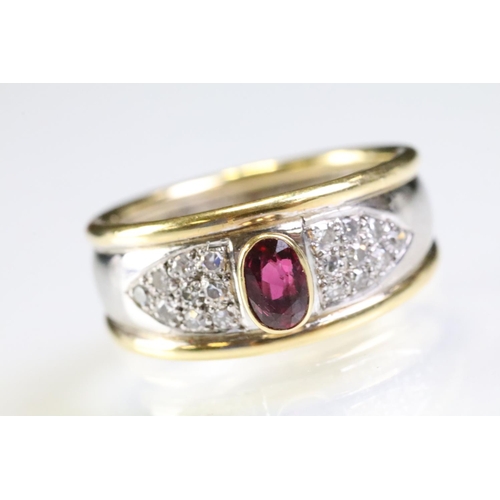 281 - 18ct gold two tone ruby and diamond ring. The ring being bezel set with a oval cut ruby to centre wi... 