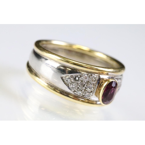 281 - 18ct gold two tone ruby and diamond ring. The ring being bezel set with a oval cut ruby to centre wi... 