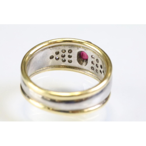 281 - 18ct gold two tone ruby and diamond ring. The ring being bezel set with a oval cut ruby to centre wi... 