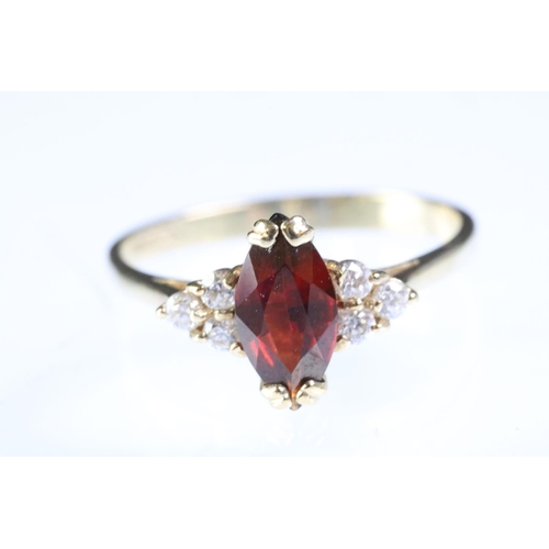 298 - 9ct gold garnet and white stone ring being set with a marquise cut garnet to centre with three white... 