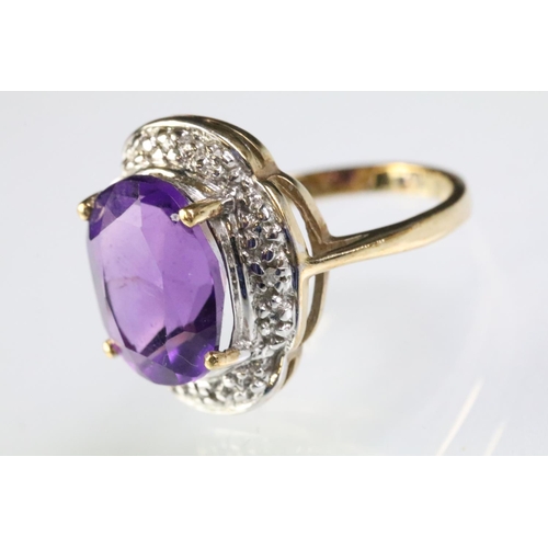 299 - 9ct gold and amethyst dress ring being set with a large oval cut amethyst to the centre with diamond... 