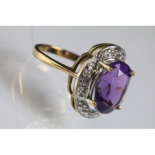 299 - 9ct gold and amethyst dress ring being set with a large oval cut amethyst to the centre with diamond... 