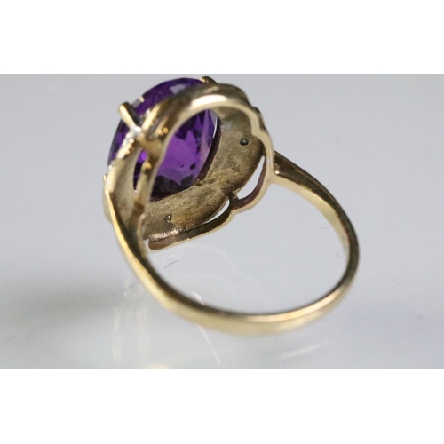 299 - 9ct gold and amethyst dress ring being set with a large oval cut amethyst to the centre with diamond... 