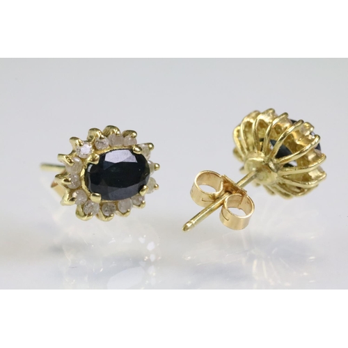 304 - Pair of sapphire and diamond cluster earrings having oval cut sapphires to the centre with a halo of... 