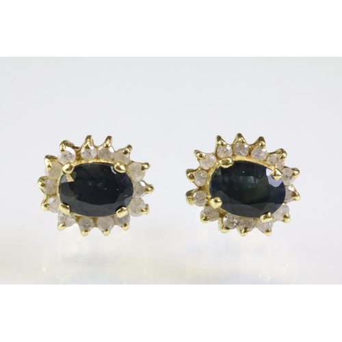 304 - Pair of sapphire and diamond cluster earrings having oval cut sapphires to the centre with a halo of... 