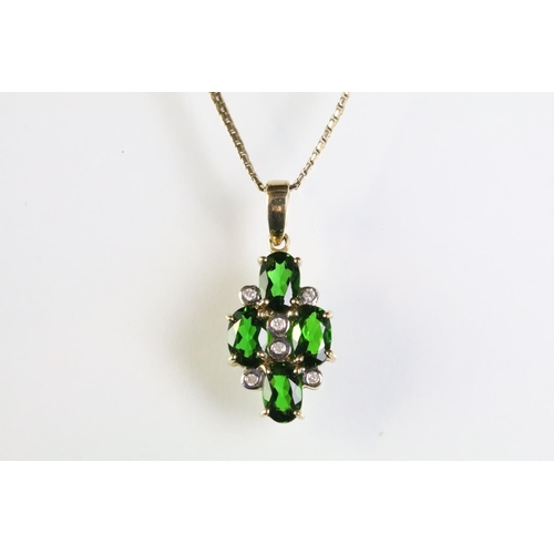 305 - 9ct gold pendant necklace being set with four oval cut chrome diopside gemstones with six bezel set ... 