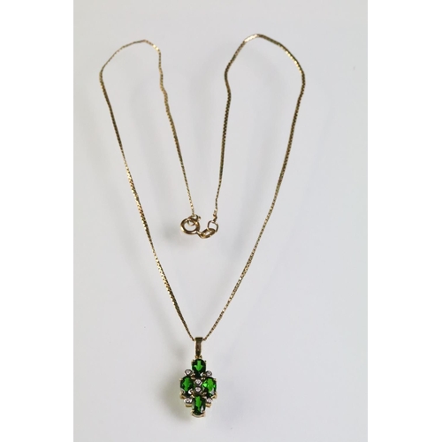 305 - 9ct gold pendant necklace being set with four oval cut chrome diopside gemstones with six bezel set ... 