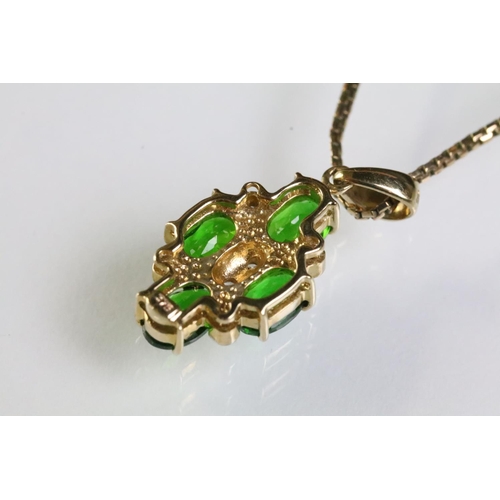 305 - 9ct gold pendant necklace being set with four oval cut chrome diopside gemstones with six bezel set ... 