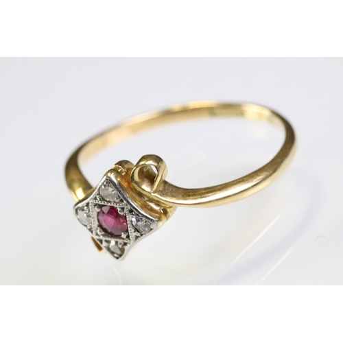 307 - 18ct gold ruby and diamond panel ring having a round cut ruby to centre surrounded by four diamond c... 