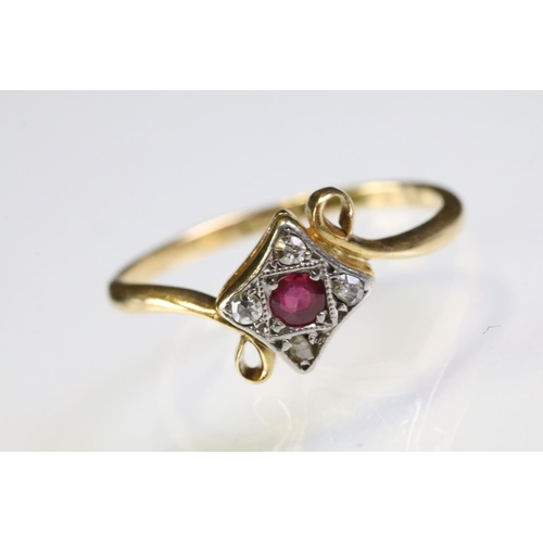 307 - 18ct gold ruby and diamond panel ring having a round cut ruby to centre surrounded by four diamond c... 