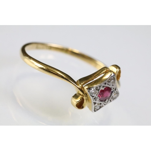 307 - 18ct gold ruby and diamond panel ring having a round cut ruby to centre surrounded by four diamond c... 