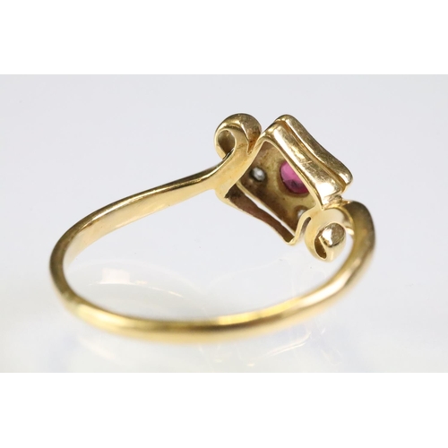 307 - 18ct gold ruby and diamond panel ring having a round cut ruby to centre surrounded by four diamond c... 